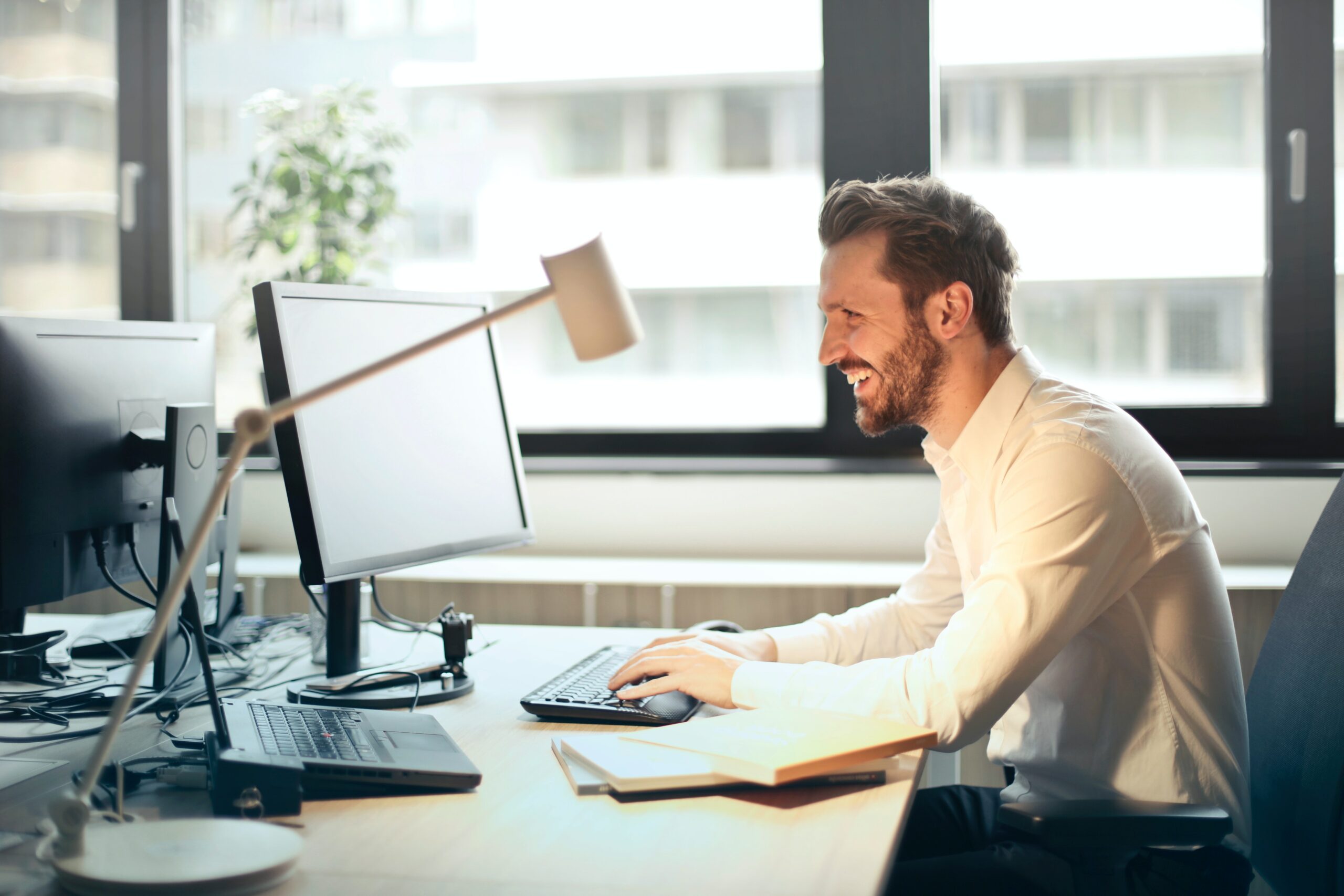 Finesse Group - Man Sitting at his desk in front of his computer